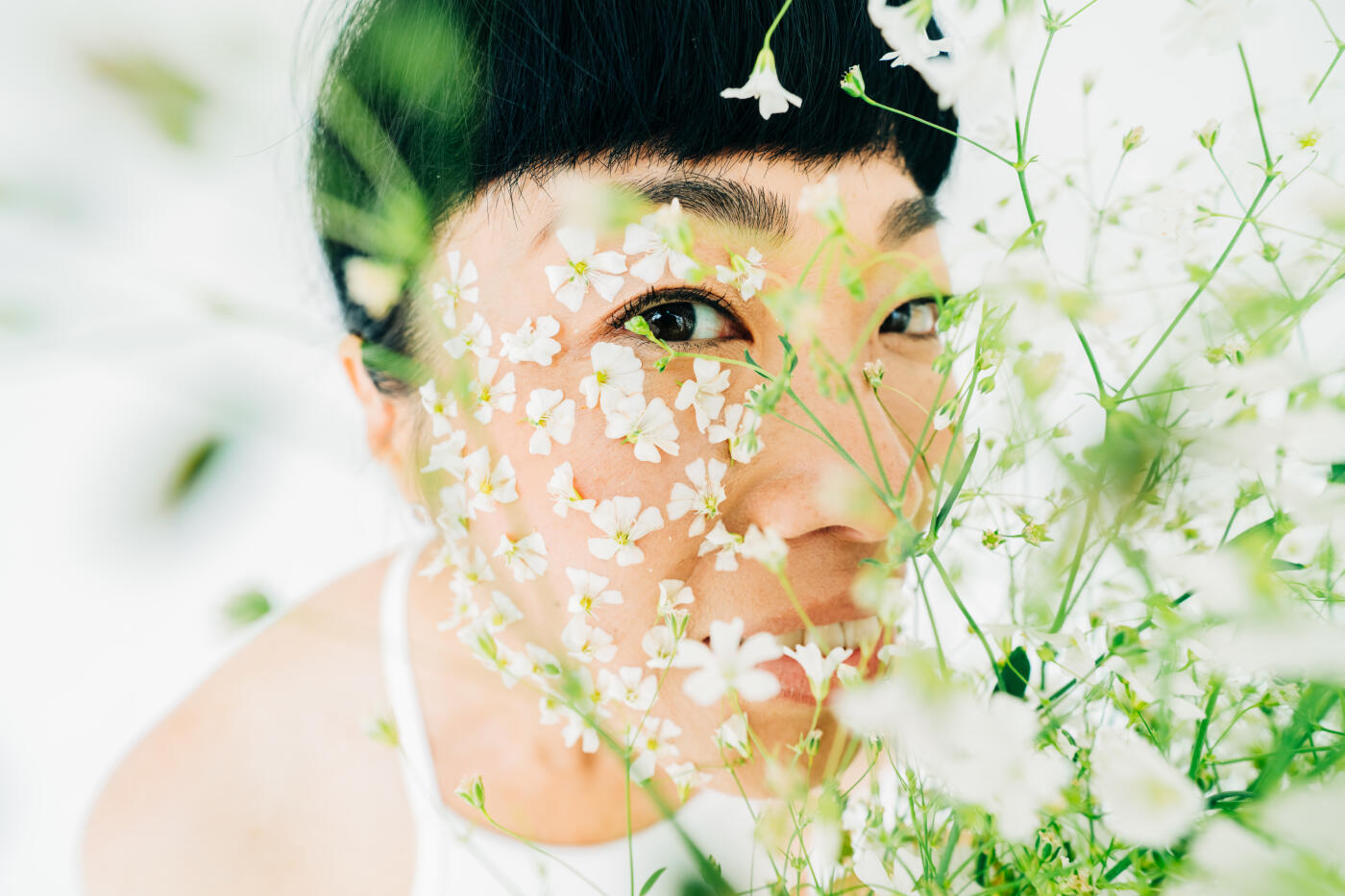 Beautiful asian woman with flowers on face, beauty and skin care concept.