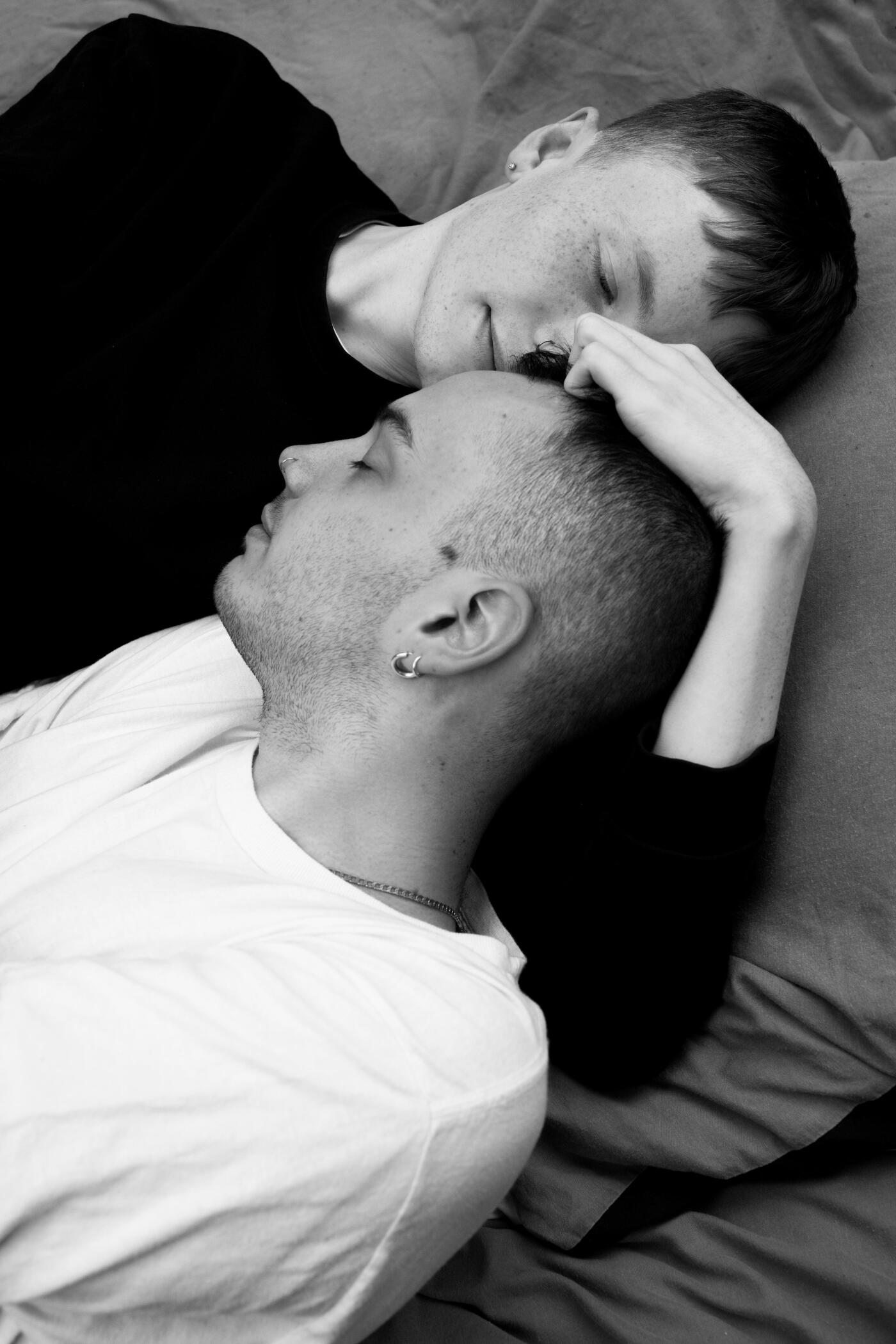 A LGBT couple hugging in bed