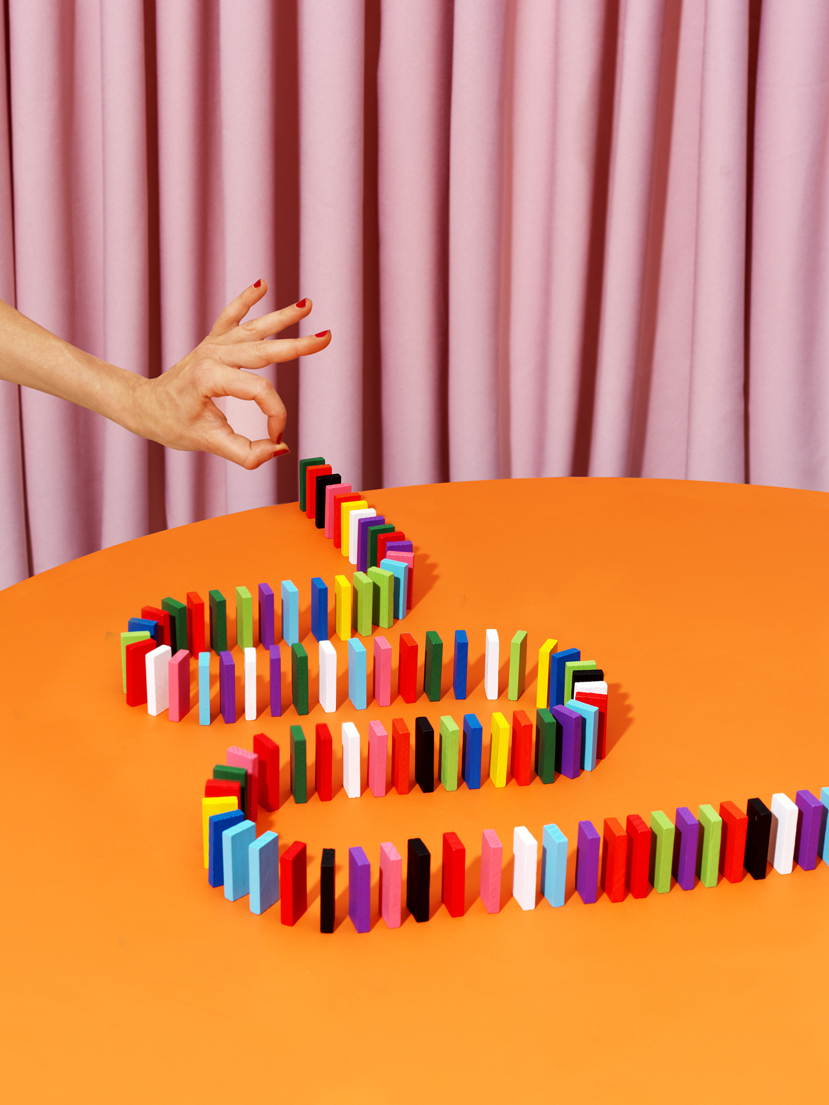 Dominos rest on a table in the midst of play.