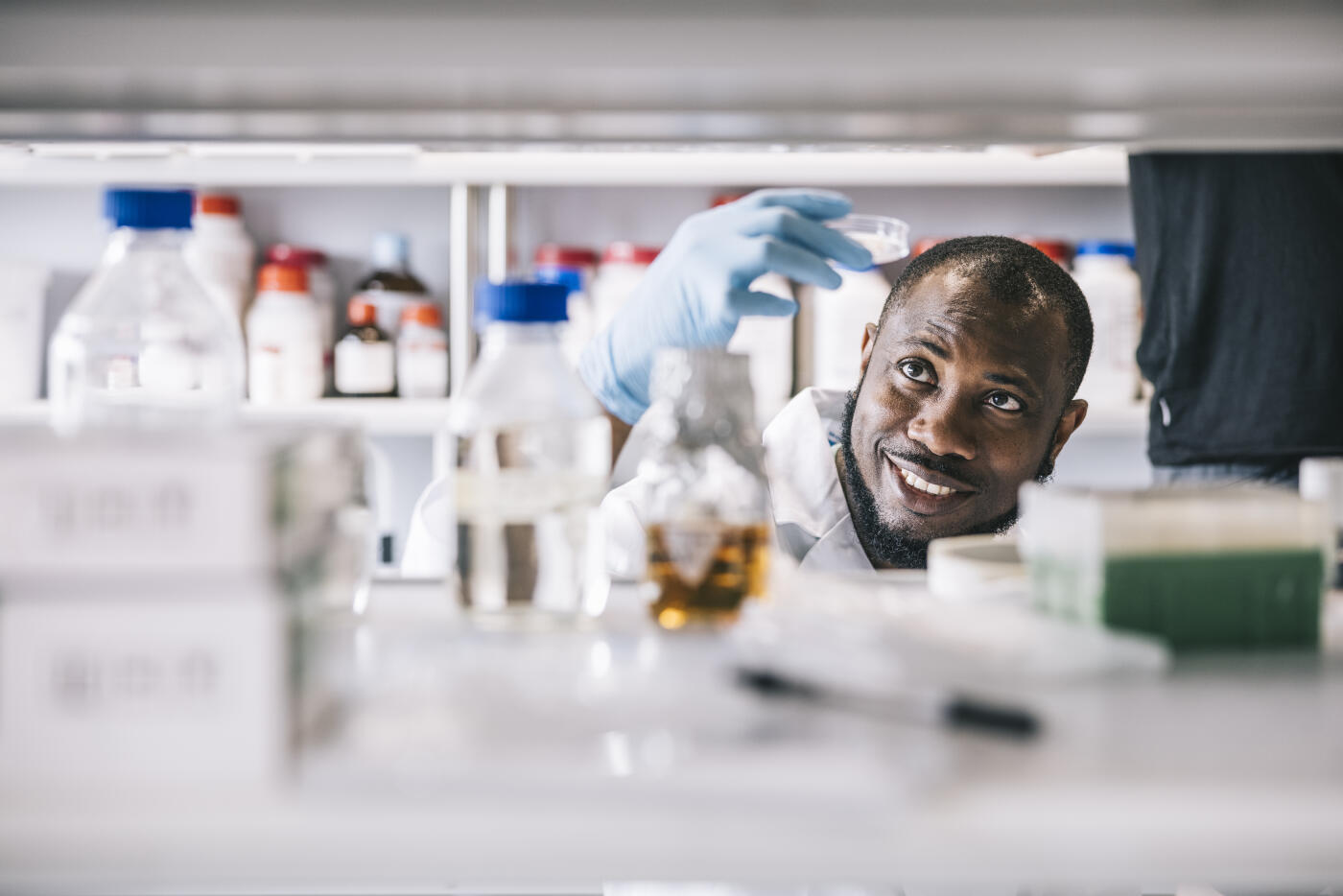 Candid portrait of black scientist making a new discovery in laboratory.