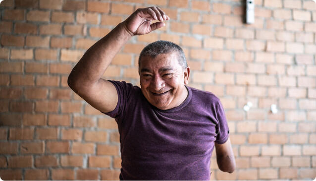 Mature man with partial arm amputation dancing on a dance class