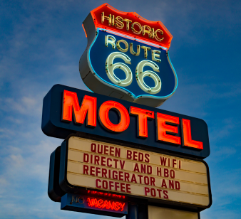 Historic Route 66 Motel neon sign glowing at sunset