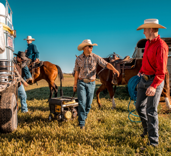 Caucasian Cowboys Preparing Horses in Rural American Countryside